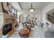 Spacious living room featuring hardwood floors, a stone fireplace, and elegant decor at 4525 King St, Denver, CO 80211