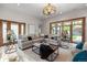Bright living room with stone floors, stylish chandeliers, modern decor, and backyard access at 4525 King St, Denver, CO 80211