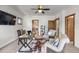 Bright home office featuring a ceiling fan, TV, rustic wood trim, and comfortable seating at 4525 King St, Denver, CO 80211