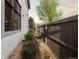 Narrow side yard with gravel bed, planter boxes, and privacy fence at 4525 King St, Denver, CO 80211
