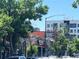 A street view with various businesses and restaurants and lush green trees at 4525 King St, Denver, CO 80211