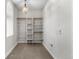 Spacious walk-in closet with custom shelving and ample storage space at 4525 King St, Denver, CO 80211