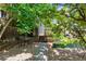 Charming backyard featuring mature trees, a cozy seating area, and a raised garden bed at 1243 N Lafayette St, Denver, CO 80218