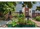 Backyard showcasing a lush garden with various plants, a seating area, and a raised wooden deck at 1243 N Lafayette St, Denver, CO 80218