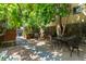 Charming backyard with mature tree coverage, featuring a table and chairs for outdoor dining and relaxing at 1243 N Lafayette St, Denver, CO 80218