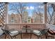 Relax on the balcony with a view of the neighborhood, featuring stylish seating and wood floors at 1243 N Lafayette St, Denver, CO 80218