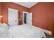Bedroom featuring warm-toned walls, multiple doors, and bright white trim at 1243 N Lafayette St, Denver, CO 80218
