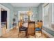 Stylish dining room with eye-catching light fixture, hardwood floors, and view into the living room at 1243 N Lafayette St, Denver, CO 80218
