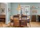 Charming dining room featuring a unique light fixture, hardwood floors, and adjacent access to the kitchen at 1243 N Lafayette St, Denver, CO 80218