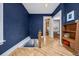 Elegant hallway with hardwood floors, deep blue walls, and intricate trim details at 1243 N Lafayette St, Denver, CO 80218