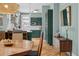 Modern kitchen with green cabinetry, stainless steel appliances, and open layout connecting to the dining area at 1243 N Lafayette St, Denver, CO 80218