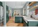 Charming kitchen with a view, featuring a farm sink, stylish cabinetry, and hardwood floors at 1243 N Lafayette St, Denver, CO 80218