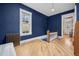 Stylish landing area with hardwood floors, a window, and a cozy bench, complemented by deep blue walls at 1243 N Lafayette St, Denver, CO 80218