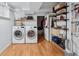 Organized laundry room with modern appliances, storage shelves, and ample workspace at 1243 N Lafayette St, Denver, CO 80218