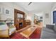 Cozy living room featuring a fireplace, piano, and open access to the dining area at 1243 N Lafayette St, Denver, CO 80218