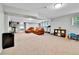 Spacious finished basement with comfortable seating and a small entertainment area at 11209 Quivas Loop, Denver, CO 80234