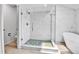 Modern bathroom featuring a glass shower with rainfall shower head and separate tub at 11209 Quivas Loop, Denver, CO 80234