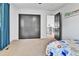 Nicely sized bedroom with a large closet and an open doorway to the hall at 11209 Quivas Loop, Denver, CO 80234