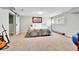 Basement bedroom featuring an accent guitar, queen bed, and egress window at 11209 Quivas Loop, Denver, CO 80234