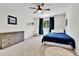 Bright bedroom featuring a ceiling fan, neutral carpet, and a large dresser for ample storage at 11209 Quivas Loop, Denver, CO 80234