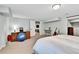 Cozy carpeted bedroom featuring a dresser, gym ball and doorway to an entertainment room at 11209 Quivas Loop, Denver, CO 80234