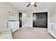 Well-lit bedroom featuring a changing table, closet, and access to a balcony at 11209 Quivas Loop, Denver, CO 80234