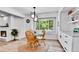 Bright breakfast nook area with hardwood floors, a round wooden table, and a large window at 11209 Quivas Loop, Denver, CO 80234