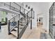 Open entryway featuring a modern staircase, light wood floors, and a view into the living spaces at 11209 Quivas Loop, Denver, CO 80234