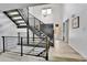 Modern entryway with vaulted ceilings, staircase and view of the front door at 11209 Quivas Loop, Denver, CO 80234