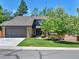 Charming home with a well-manicured lawn and a two-car garage provides great curb appeal at 11209 Quivas Loop, Denver, CO 80234