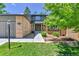 Charming two-story home featuring a lovely green lawn, garden, and entryway at 11209 Quivas Loop, Denver, CO 80234