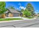 A beautiful two-story home shows off its well-maintained lawn, driveway, and landscaping at 11209 Quivas Loop, Denver, CO 80234