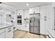 Modern white kitchen featuring stainless steel refrigerator, built-in oven and microwave combination at 11209 Quivas Loop, Denver, CO 80234