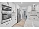 Close up of a modern white kitchen with stainless steel appliances and granite countertops at 11209 Quivas Loop, Denver, CO 80234