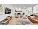 Inviting living room with cozy fireplace, comfortable seating, hardwood floors and large television at 11209 Quivas Loop, Denver, CO 80234