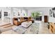 Modern living area with hardwood floors, a large sofa, and access to an outdoor deck or patio at 11209 Quivas Loop, Denver, CO 80234