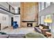 Spacious living room featuring a brick fireplace, hardwood floors, and abundant natural light from large windows at 11209 Quivas Loop, Denver, CO 80234
