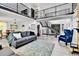 Bright living room with soaring ceilings, staircase, and open floor plan at 11209 Quivas Loop, Denver, CO 80234