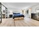 Spacious main bedroom featuring ensuite bathroom, hardwood floors, and abundant natural light at 11209 Quivas Loop, Denver, CO 80234