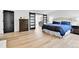 Comfortable main bedroom with ensuite bathroom, hardwood floors, and black barn doors at 11209 Quivas Loop, Denver, CO 80234