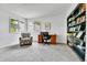 Well-lit home office with custom built-in bookcase and large windows at 11209 Quivas Loop, Denver, CO 80234