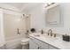 Bright bathroom with a shower and tub, updated vanity, modern fixtures and light at 3450 S Poplar St # 109, Denver, CO 80224