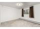 The carpeted bedroom features neutral walls, modern window, and a minimalist design at 3450 S Poplar St # 109, Denver, CO 80224
