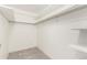 A bright closet is shown with shelving and a clothes rod for extra storage space at 3450 S Poplar St # 109, Denver, CO 80224
