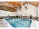Beautiful indoor pool with open-beam wood ceilings and large windows at 3450 S Poplar St # 109, Denver, CO 80224