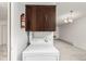 Laundry area with stacked washer and dryer and a cabinet mounted above at 3450 S Poplar St # 109, Denver, CO 80224