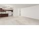 Open concept living space featuring a kitchen and living room with neutral carpeting at 3450 S Poplar St # 109, Denver, CO 80224