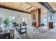 Open lobby area with brick fireplace and lots of light at 3450 S Poplar St # 109, Denver, CO 80224