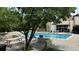 A refreshing community pool surrounded by lush greenery and comfortable lounge chairs at 3450 S Poplar St # 109, Denver, CO 80224