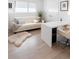 Bright home office features a white leather sofa, large desk, and hardwood floors at 62 N Jasmine St, Denver, CO 80220